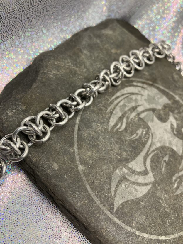 A silver chainmaille chain in the weave known as Rhinos Snorting Draino.