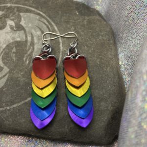 Scalemail earrings with overlapping scales forming a straight down pattern. These earrings are six scales long, approximately 2 and one half inches, and have colors representing the traditional pride flag--red, orange, yellow, green, blue, and purple.